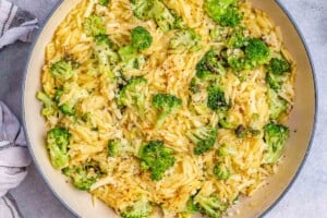 Broccoli cheddar orzo in a pan.