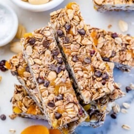 Healthy ganola bars with nuts, oats, and chocolate chips stacked over each other.
