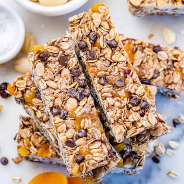 Healthy ganola bars with nuts, oats, and chocolate chips stacked over each other.