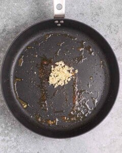 minced garlic in a pan to be seared.