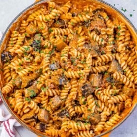 pasta with eggplant and tomato sauce in a skillet.