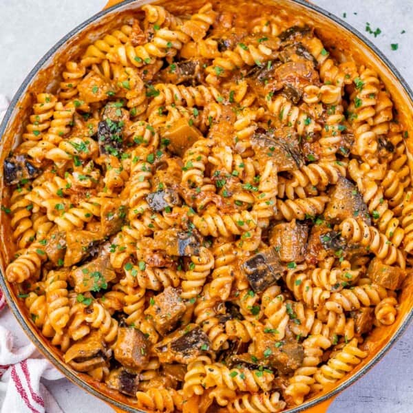 pasta with eggplant and tomato sauce in a skillet.