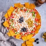 a round bowl with taco dip, thats a spider web theme.