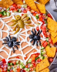 Top view close-up of the olive spiders sitting on the sour cream spider web.