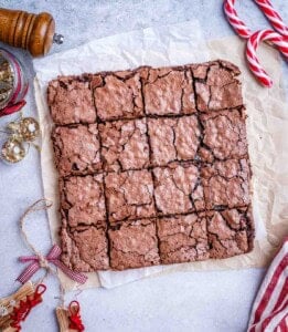 Freshly baked and sliced peppermint brownies resting on parchment paper.