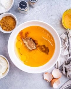 a bowl with pumpkin puree, eggs, oil, and sugar before blending.