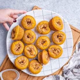 a plate with pumpkin muffins.