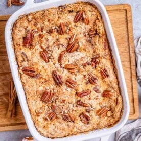 a casserole with pumpkin dump cake topped with pecans.
