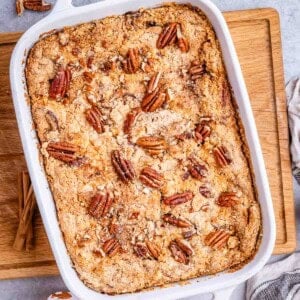 a casserole with pumpkin dump cake topped with pecans.