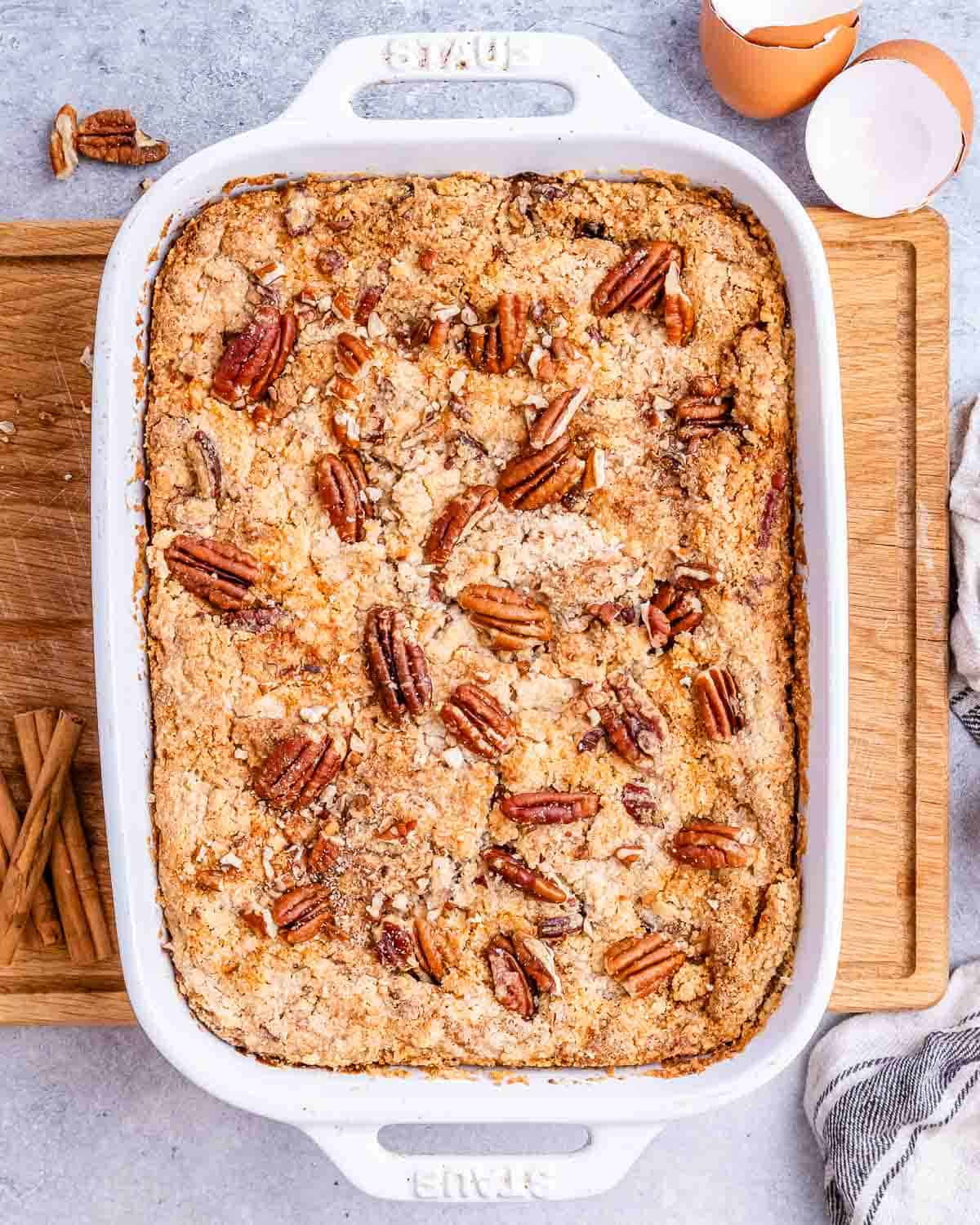 pumpkin dump cake in a white casserole dish.