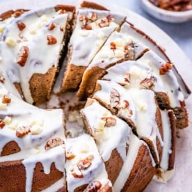 sliced bundt cake made with a sweet potato base, topped with white chocolate glaze.
