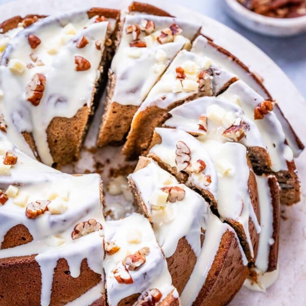sliced bundt cake made with a sweet potato base, topped with white chocolate glaze.