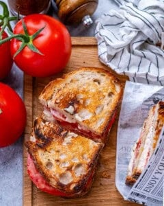 A sandwich cut in half on a cutting board.