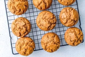 Muffins being cooled on a wire rack.