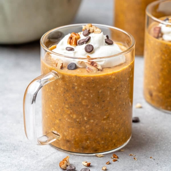 a cup filled with pumpkin overnight oats.