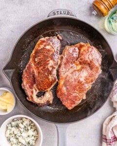 2 cooked steak on a black skillet
