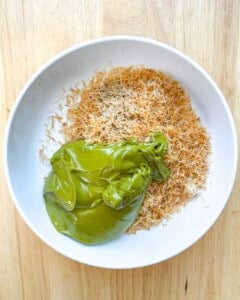kataifi in a bowl with added pistachio cream and tahini.