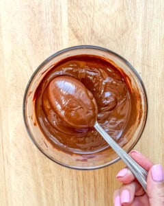 spoon in melted chocolate in a bowl.
