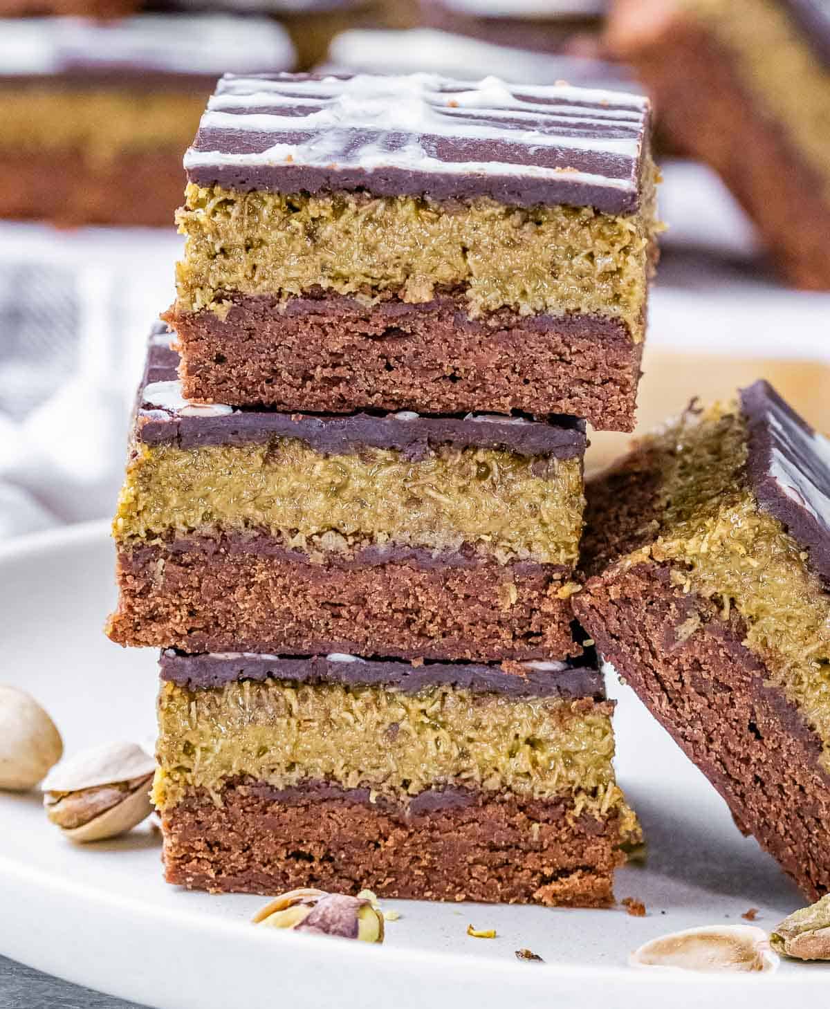 A stack of Dubai brownies with pistachios and ganache topping.