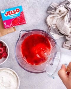 Water is being added to the Jell-O powder mix.