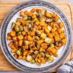roasted sweet potato and brussels sprouts on a plate.