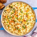 mac and cheese with veggies in a skillet.