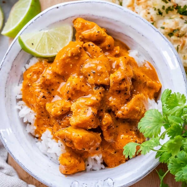 chicken curry over white rice in a bowl.
