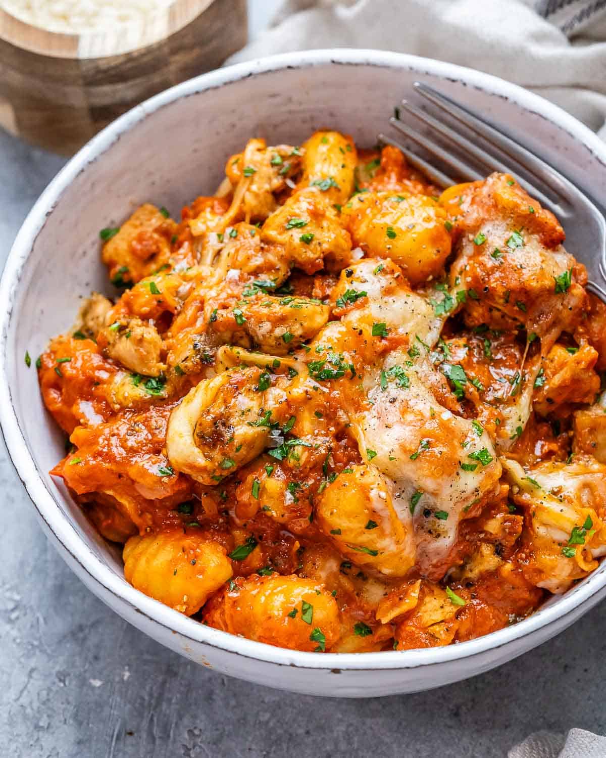 a bowl with chicken and gnocchi.