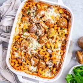 a chemical with meatball and pasta with tomato sauce and veggies.