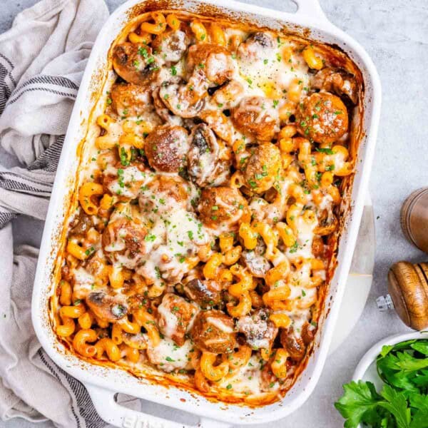 a chemical with meatball and pasta with tomato sauce and veggies.