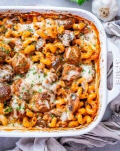 Dump and bake meatball casserole in a white casserole dish.