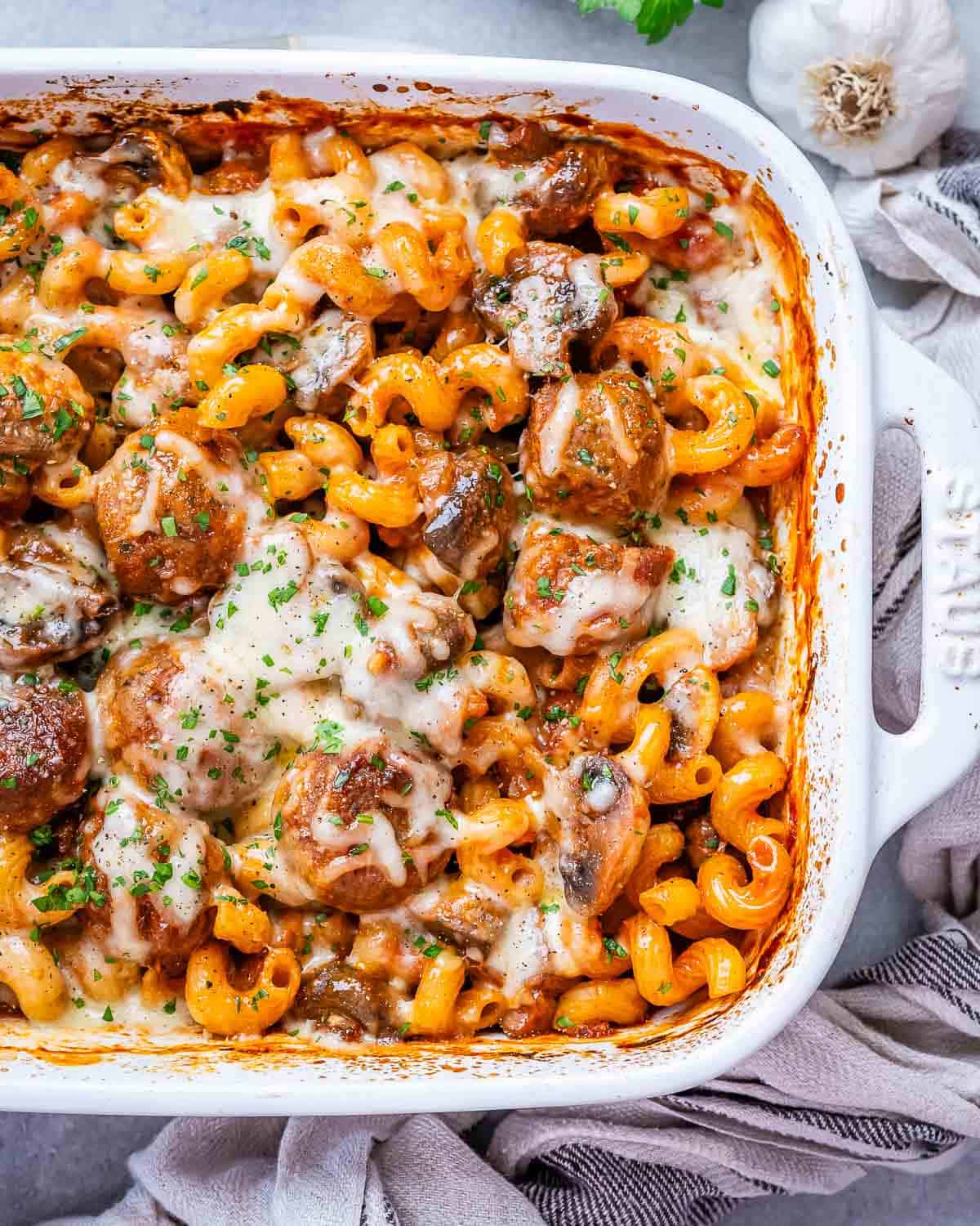 Dump and bake meatball casserole in a white casserole dish.