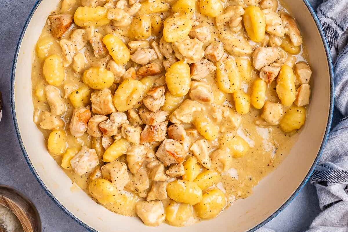 creamy chicken and gnocchi in a skillet.