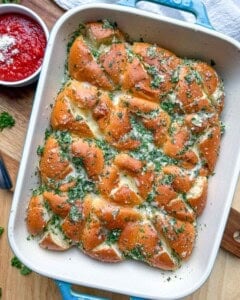 hawaiian dinner rolls with garlic butter in a baking dish.