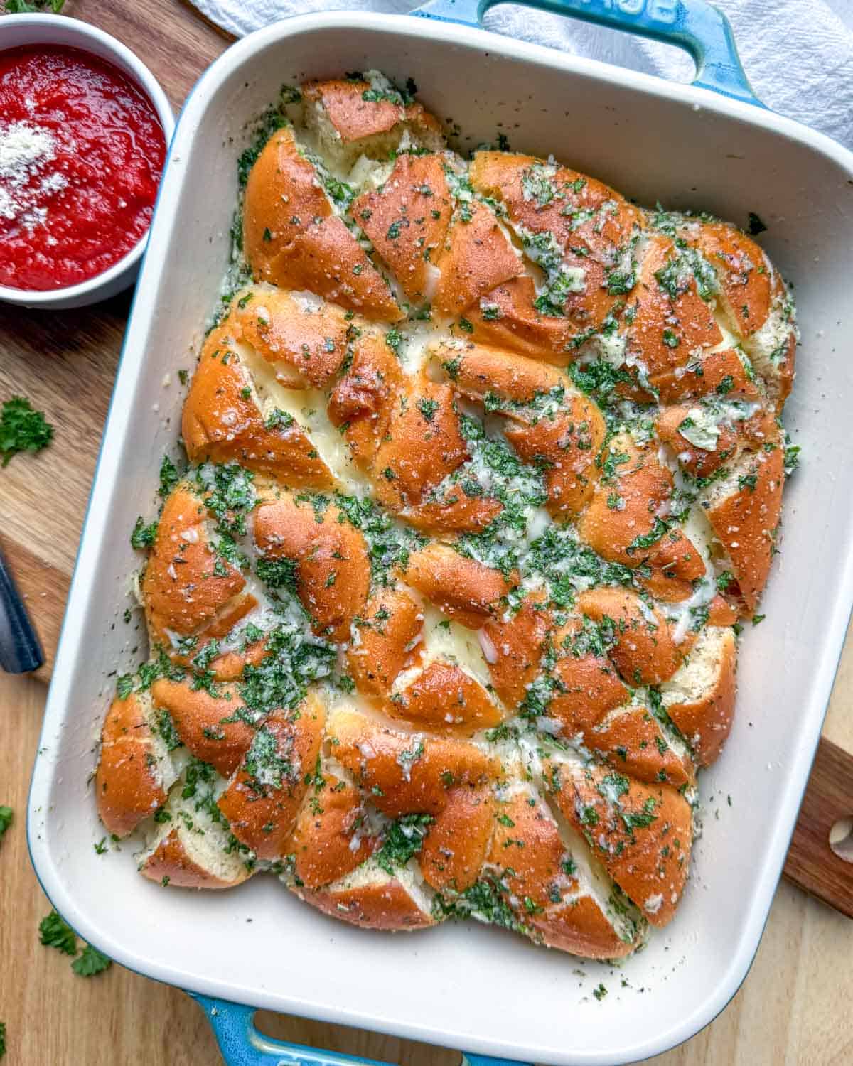 hawaiian dinner rolls with garlic butter in a baking dish.