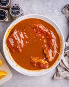 steak marinated on a plate.