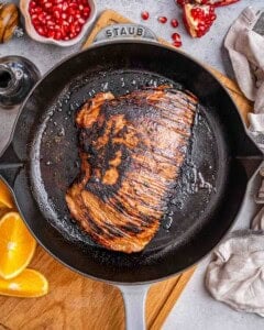 flank steak seared on a skillet.
