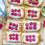 8 raspberry cheese danish squares on a sheet pan.