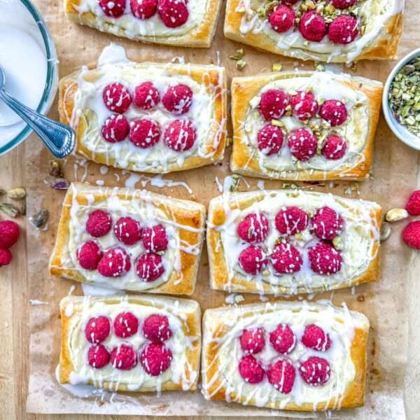 8 raspberry cheese danish squares on a sheet pan.