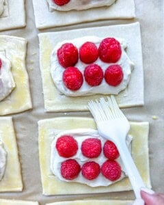 Brush egg wash on the puff pastry.