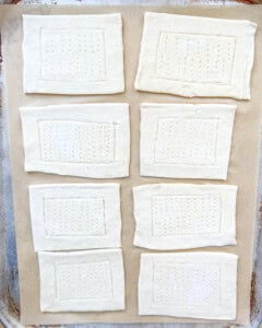 puff pastry dough squares on a sheet pan.