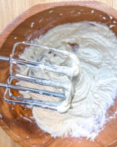 whisking the cream cheese filling for the Danish in a bowl.