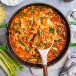 a pot with vegetarian lasagna and a spoon in the pot.