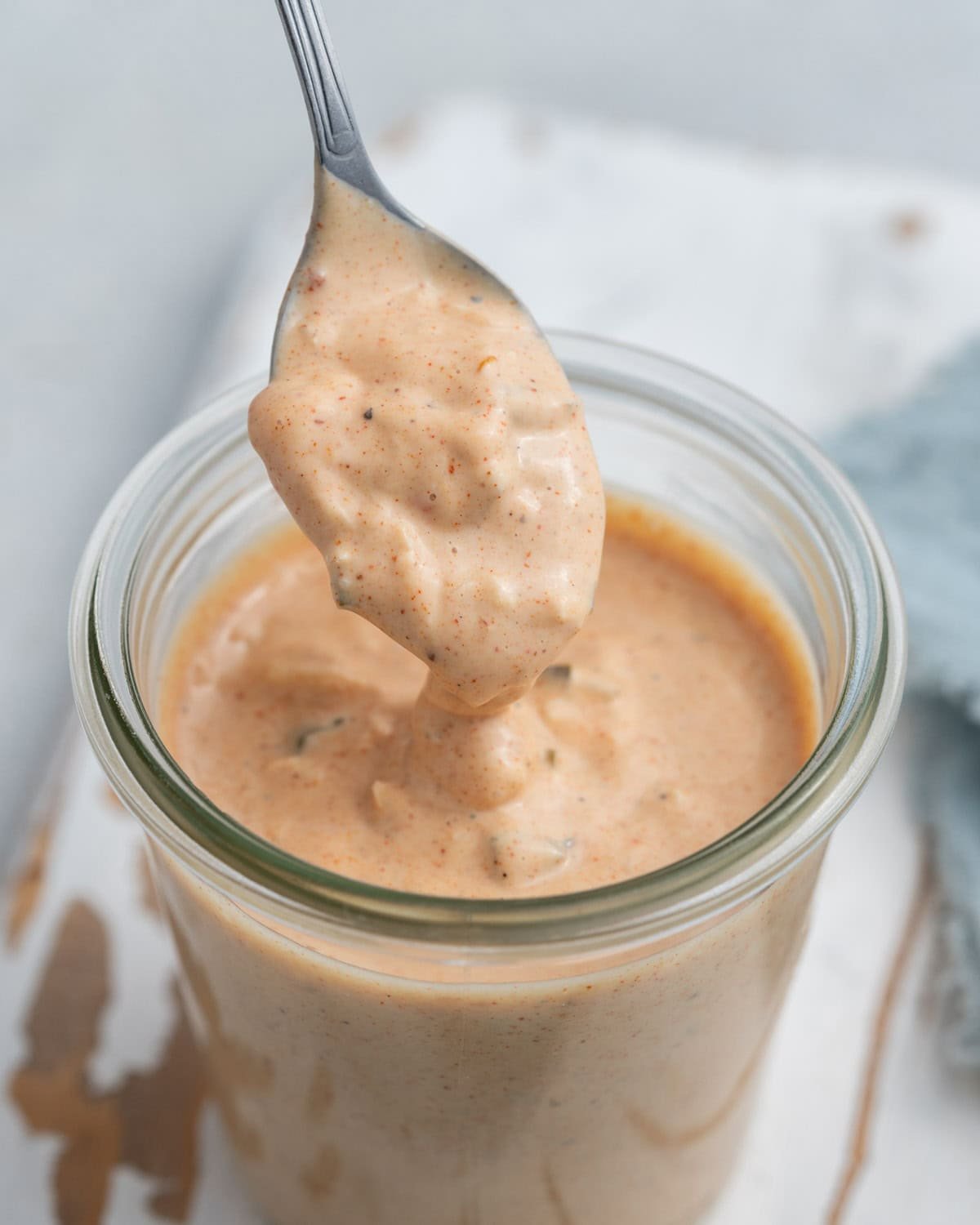 spoonful of big mac sauce over a jar.