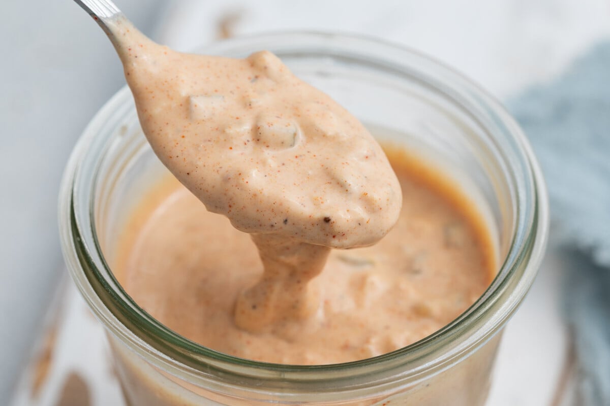 a spoonful of big mac sauce over the jar with the sauce.