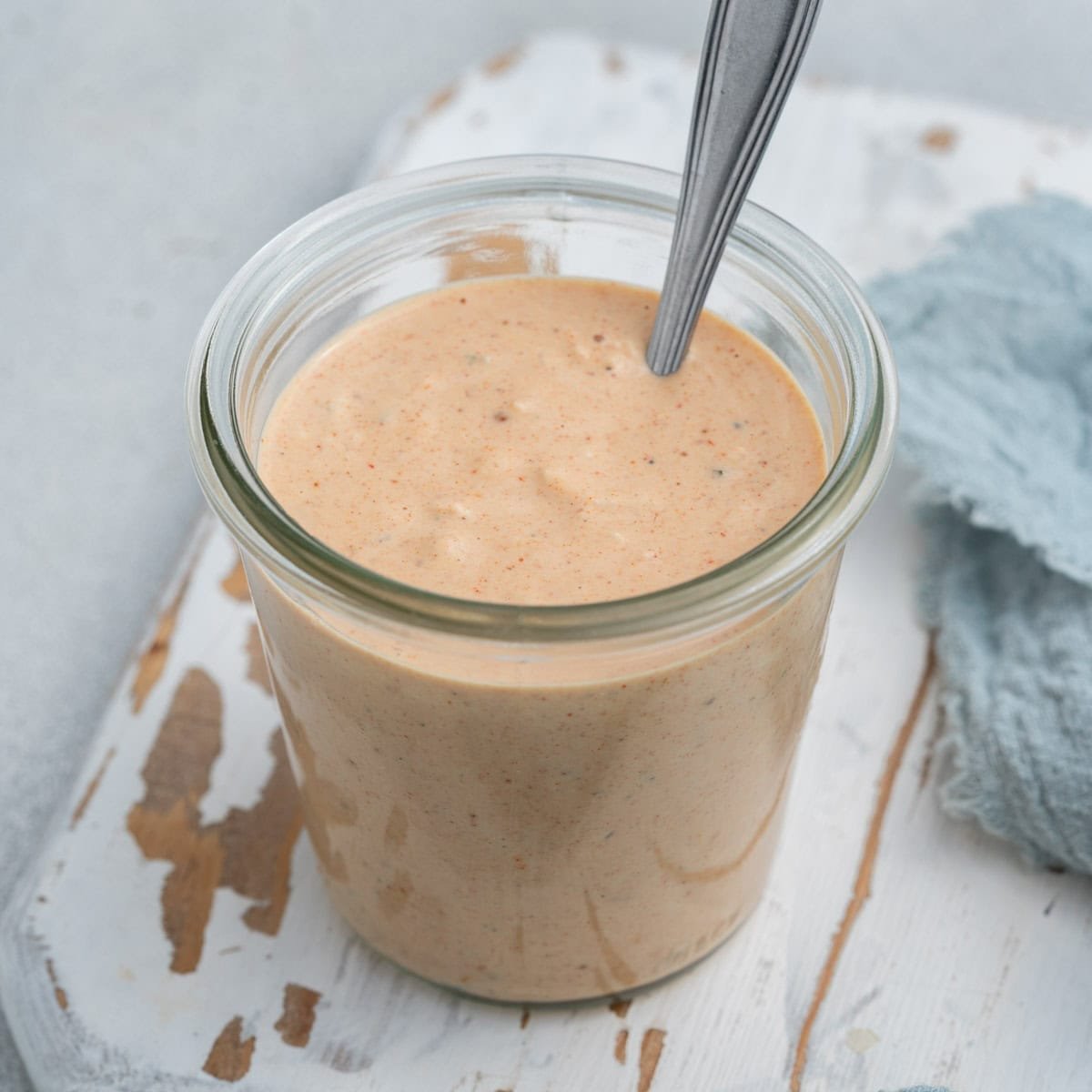Big Mac sauce in a jar with a spoon in it.