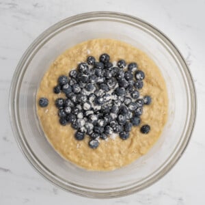 coated blueberries added over the muffin batter.
