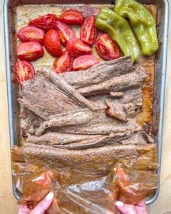 unravelling the beef doner from the parchment paper.