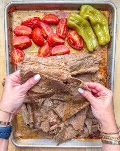 breaking the doner beef sheets on the pan.