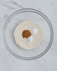 dry flour ingredients added to a bowl.
